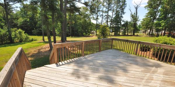 Wood deck in big green backyard