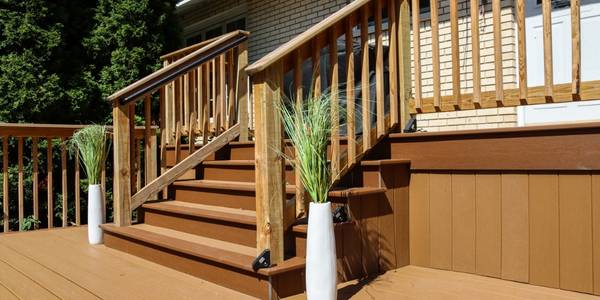 wood deck with 2 plants by the stairs