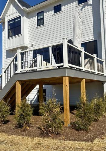 raised backyard deck with white railing